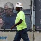 Laborer Randall Turner walked past an advertisement for the Pier 4 development on Northern Avenue. 