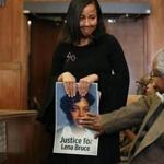 Eva Mitchell carried a photo of Lena Bruce as she arrived for the sentencing of James Witkowski at Suffolk Superior Court Thursday. Eva Mitchell was Lena Bruce's sorority sister at Delta Sigma Theta Sorority, Inc.