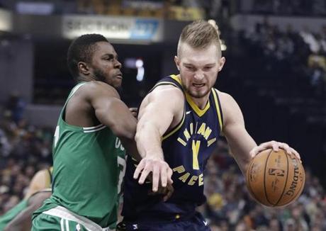 Indiana Pacers' Domantas Sabonis is defended by Boston Celtics' Semi Ojeleye during the first half of an NBA basketball game, Monday, Dec. 18, 2017, in Indianapolis. (AP Photo/Darron Cummings)
