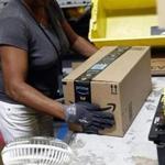 ADVANCE FOR SUNDAY, OCT. 29, 2017, AND THEREAFTER - In this Aug. 3, 2017, photo, Myrtice Harris applies tape to a package before shipment at an Amazon fulfillment center in Baltimore. While jobs have been lost in brick-and-mortar stores, many more have been gained from e-commerce and warehousing. Amazon accounts for much of the additional employment. (AP Photo/Patrick Semansky)