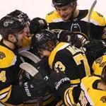 Boston-12/21/2017 Boston Bruins vs Winnipeg Jets- Bruins Charlie McAvoy is congratulated by teammates including Jake DeBrusk after his overtime winning goal. John Tlumacki/Globe staff (sports)