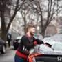 Andy Supinski of Dorchester donned his best holiday sweater to scrape ice off his car.