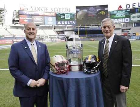 Coach Steve Addazio (left) and Boston College face coach Kirk Ferentz and Iowa in the Pinstripe Bowl at Yankee Stadium on Wednesday. 
