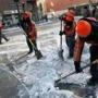 Workers for the Downtown Boston Business Improvement District cleared ice and snow from the intersection of Arch and Summer Streets.