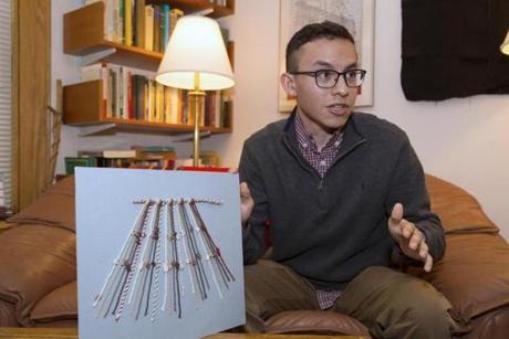 Manny Medrano displays a model of khipu knots, an information system that the Inca used to tally and record data. Medrano, now a junior at Harvard, is the first name on the paper he co-wrote with Gary Urton, Dumbarton Oaks Professor of Pre-Columbian Studies at Harvard, that is being published in EthnoJournal.
