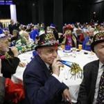 Joseph Carcerano of Brighton (center) and Dennis DeMello of Brighton (right) used noisemakers as they counted down to an early New Year at the Seaport World Trade Center on Thursday.