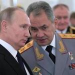 Russian President Vladimir Putin, left, and Defence Minister Sergei Shoigu talk during an awards ceremony for troops who fought in Syria, in the Kremlin, in Moscow, Russia, Thursday, Dec. 28, 2017. President Vladimir Putin says Russia's action in Syria has demonstrated the power of the nation's modernized military to the world. (Alexei Druzhinin, Sputnik, Kremlin Pool Photo via AP)