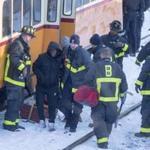 Firefighters help injured passengers off of a Mattapan line trolley after it crashed near Cedar Grove Station on Friday.
