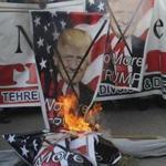 Pakistani protesters burned banners showing US President Donald Trump in Hyderabad, Pakistan, Tuesday. 