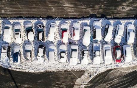 STORM SLIDER 01/05/2018 GLOUCESTER, MA Cars had broken windows and water damage in a parking lot that flooded during yesterday's blizzard at Gloucester High School. (Aram Boghosian for The Boston Globe)
