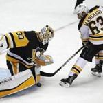 Boston Bruins' Brad Marchand (63) is stopped on a penalty shot by Pittsburgh Penguins goaltender Matt Murray (30) in the third period of an NHL hockey game in Pittsburgh, Sunday, Jan. 7, 2018. The Penguins won in overtime 6-5. (AP Photo/Gene J. Puskar)