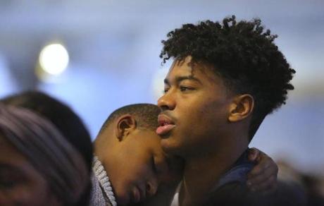 Yuran Teixeira, 18, held his brother Jonah Carvalho, 5, during an Epiphany Mass on Sunday at St. Peter?s Parish on Bowdoin Street, in the center of Boston?s Cape Verdean community.
