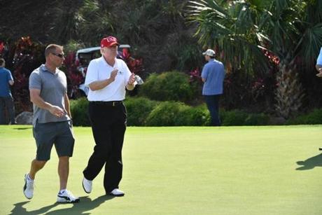 President Donald Trump walked with US Coast Guard Chief Warrant Officer Gene Gibson at Trump International Golf Course in Florida last month. Trump had invited members of the Coast Guard to play golf at the resort to thank them personally for their service of patrolling the nearby waters off Palm Beach and Mar-a-Lago. 
