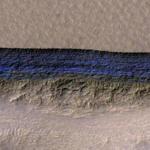 A cross-section of a thick sheet of underground ice is exposed at the steep slope that appears bright blue in this enhanced-color view from the High Resolution Imaging Science Experiment (HiRISE) camera on NASA's Mars Reconnaissance Orbiter. MUST CREDIT: Photo by NASA/JPL-Caltech/UA/USGS