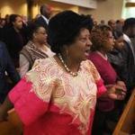 Gloria Savory joined with others on Sunday in singing ?We Shall Overcome? during the annual Dr. Martin Luther King Jr. Convocation at Twelfth Baptist Church in Roxbury, where King was a minister in the early 1950s. 