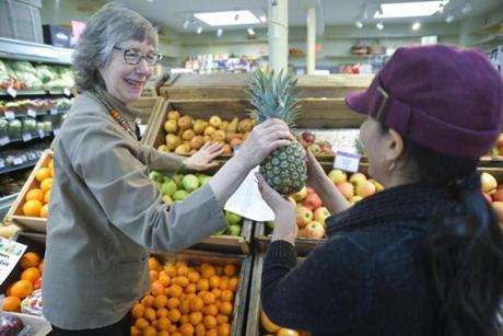 Debra Stark, left, of Debra?s Natural Gourmet passed fruit to employee Gregoria Vanhoogen.
