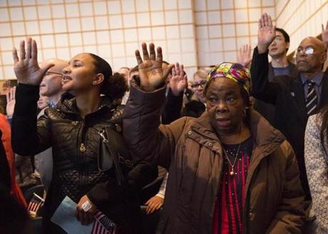Anna Nwaibari Okoro (right), from Nigeria, joined others for the citizenship oath Wednesday at the John F. Kennedy Presidential Library and Museum in Boston.
