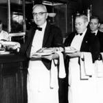 Boston, MA - 5/29/1957: From left, waiters Charles Bischoff, Pat Donovan, Ernie Kunstler and Alfred Elias pick up their plates inside Jacob Wirth Co. in Boston, May 29, 1957. (Bill O'Connor/Globe Staff) --- BGPA Reference: 180118_ON_001