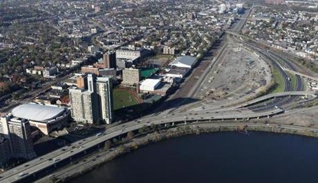 Harvard University is nearly doubling its contribution toward new train service in Allston, disappointed with the state?s plans to delay the opening of a new commuter station there.
