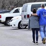 Families escorted their children out of Marshal North Middle School near Palma, Ky., after the students where brought there from Marshal High School, where two students had been shot to death. 