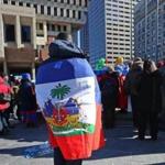 A demonstrator covered his back with a Haitian flag.