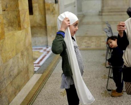 Amani Fadli, 8, attended Muslim Lobby Day at the Massachusetts State House Tuesday. Fadli prepared her hijab before the events.
