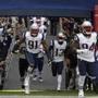 New England Patriots players including defensive tackle Deatrich Wise (91 run out of the tunnel before an NFL football game against the Oakland Raiders, Sunday, Nov. 19, 2017, in Mexico City. (AP Photo/Rebecca Blackwell)