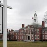 FILE - This April 11, 2016 photo shows a portion of the prestigious Phillips Exeter Academy campus in Exeter, N.H. Police recommended two deans from the prep school be arrested on misdemeanor charges for failing to properly report allegations that a male student groped a female classmate. A state police report from November 2016, obtained by the Associated Press, showed that arrest warrants had been prepared for Phillips Exeter Academy's Arthur J. Cosgrove and Melissa D. Mischke. (AP Photo/Jim Cole, File)