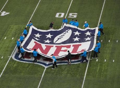 Workers placed the NFL logo on the turf at US Bank Stadium in Minneapolis.
