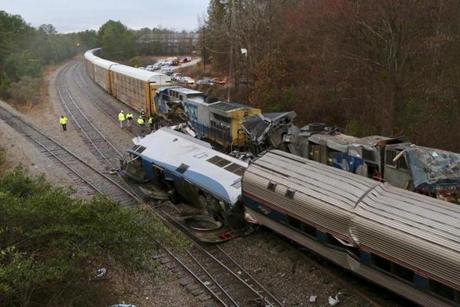 Authorities investigate the scene of a fatal Amtrak train crash in Cayce, South Carolina, Sunday, Feb. 4, 2018. At least two were killed and dozens injured. (Tim Dominick/The State via AP)
