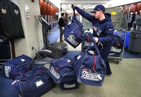 Foxborough -02/05/18 The New England Patriots arrived back at Gillette after their superbowl loss to the Eagles. A staff member throws players equipment bags from a cart in front of the players lockers in a pretty much empty locker room. John Tlumacki /The Boston Globe(sports)

