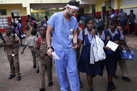 Jada ,10, grabbed onto Michael Golub's hand as he was passing through the courtyard at Brown's Town Primary School in Jamaica. She had not been seen by a dentist and had a tooth that was painful and needed to be extracted. 
