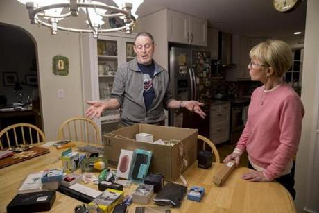 Mike and Kelly Gallivan in their Acton home, where they have received more than 20 packages from Amazon ? but they ordered none of them.
