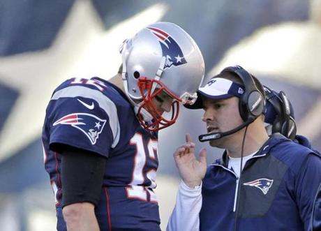 FILE - In this Dec. 4, 2016, file photo, New England Patriots quarterback Tom Brady (12) confers with offensive coordinator Josh McDaniels during the first half of an NFL football game against the Los Angeles Rams, in Foxborough, Mass. Patriots offensive coordinator Josh McDaniels says he?s become a much better person and coach for having had a second stint with Tom Brady and Bill Belichick. (AP Photo/Elise Amendola, File)

