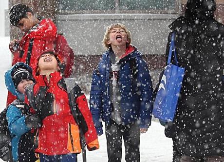 Angier Elementary School students, including Ryan Dawley (center), tried to catch snowflakes on their tongues in Newton.
