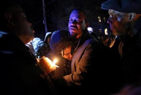 Edson Brito and his daughter Tamia embrace following a vigil in memory of his two sons, 8-year-old Edson Brito and 5-year-old Lason Brito, in Brockton on Thursday.

