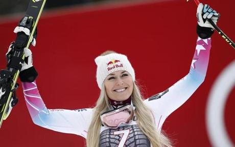 United States' Lindsey Vonn celebrates on the podium after winning an alpine ski, women's world Cup downhill race, in Garmisch Partenkirchen, Germany, Sunday, Feb. 4, 2018. (AP Photo/Gabriele Facciotti)
