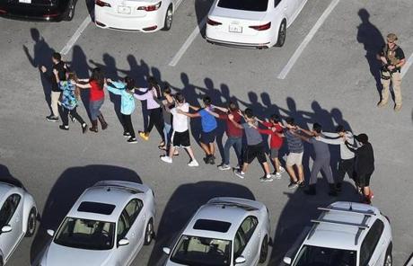 SCHOOL SHOOTING SLIDER PARKLAND, FL - FEBRUARY 14: People are brought out of the Marjory Stoneman Douglas High School after a shooting at the school that reportedly killed and injured multiple people on February 14, 2018 in Parkland, Florida. Numerous law enforcement officials continue to investigate the scene. (Photo by Joe Raedle/Getty Images) *** BESTPIX ***
