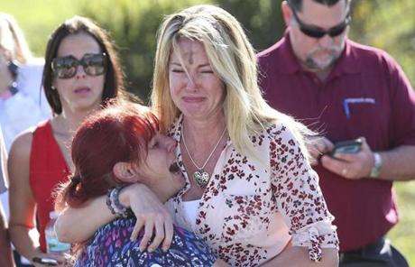 SCHOOL SHOOTING SLIDER Parents wait for news after a reports of a shooting at Marjory Stoneman Douglas High School in Parkland, Fla., on Wednesday, Feb. 14, 2018. (AP Photo/Joel Auerbach)
