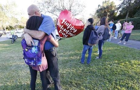 SCHOOL SHOOTING SLIDER Family member embrace following a shooting at Marjory Stoneman Douglas High School, Wednesday, Feb. 14, 2018, in Parkland, Fla. (AP Photo/Wilfredo Lee)
