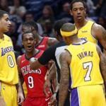 New Orleans Pelicans guard Rajon Rondo (9) and Los Angeles Lakers guard Isaiah Thomas (7) are separated by an official during the first half of an NBA basketball game in New Orleans, Wednesday, Feb. 14, 2018. Both players were ejected. (AP Photo/Gerald Herbert)