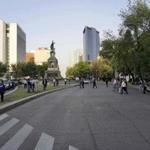 People walked to the streets as they evacuated Reforma Avenue's buildings during a powerful earthquake in Mexico City on Friday.
