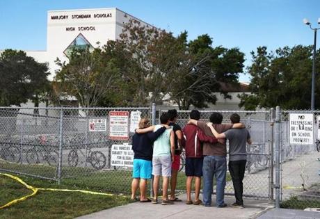 PARKLAND, FL - FEBRUARY 18: People look on at the Marjory Stoneman Douglas High School on February 18, 2018 in Parkland, Florida. Police arrested 19 year old former student Nikolas Cruz for the mass shooting that killed 17 people on February 14. (Photo by Joe Raedle/Getty Images)
