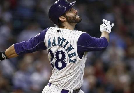Arizona Diamondbacks' J.D. Martinez watches the flight of his fly ball during the seventh inning of a baseball game against the Colorado Rockies Thursday, Sept. 14, 2017, in Phoenix. The Diamondbacks defeated the Rockies 7-0. (AP Photo/Ross D. Franklin)
