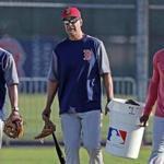 Fort Myers, FL 2/21/2018: Former Red Sox 3B and World Series MVP Mike Lowell (center) helps carry a bucket of baseballs in from a practice field session. It was the final day of workouts at Spring Training for the Red Sox today at the Player Development Complex at Jet Blue Park. The team begins exhibition games with a doubleheader vs college teams tomorrow. (Jim Davis/Globe Staff)