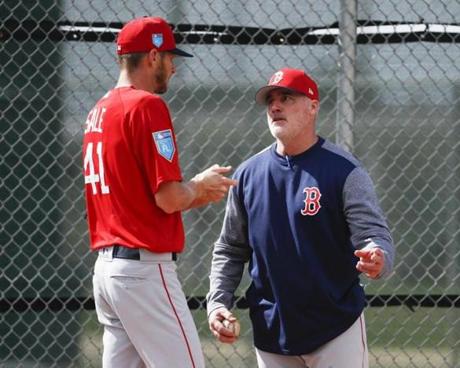 Boston Red Sox starting pitcher Chris Sale (41) and pitching coach Dana LeVangie speak during baseball spring training, Wednesday, Feb. 14, 2018, in Fort Myers, Fla. (AP Photo/John Minchillo)
