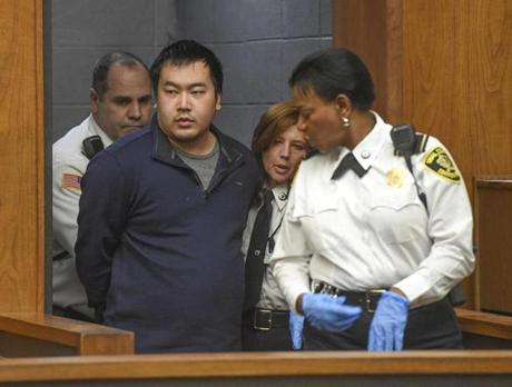 Jeffrey Yao is brought into Woburn District Court, Monday, Feb. 26, 2018 in Woburn, Mass. Yao is arraigned on murder charges and attempted murder after allegedly stabbing a woman to death and attempting to stab a man to death in the Winchester Public Library. (Faith Ninivaggi/The Boston Herald via AP, Pool)
