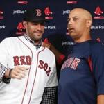 Boston Red Sox baseball player J.D. Martinez, left, meets with manager Alex Cora during a news conference announcing his signing with the team, Monday, Feb. 26, 2018, in Fort Myers, Fla. (AP Photo/John Minchillo)