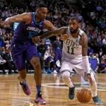Boston, MA - 2/28/2018 - (2nd quarter) Boston Celtics guard Kyrie Irving (11) drives past Charlotte Hornets center Dwight Howard (12) in the second quarter. The Boston Celtics host the Charlotte Hornets at TD Garden. - (Barry Chin/Globe Staff), Section: Sports, Reporter: Adam Himmelsbach, Topic: 01 Celtics-Hornets, LOID: 8.4.1096457932.