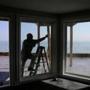 Marshfield, MA- March 01, 2018: Derek Affsa works on boarding up the windows on his home in the Brant Rock neighborhood of Marshfield, MA on March 01, 2018. He said he installed hurricane strength windows while renovating the home but he worries about the weight of the sand mixed with the waves in the coming storm. 